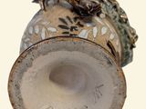 a picture of a vase with a frog on it