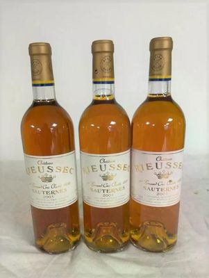 three bottles of wine sitting on a table next to each other
