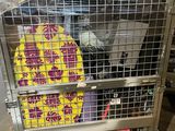 a metal cage with a bunch of items inside of it