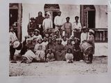 a group of people posing for a picture in front of a building