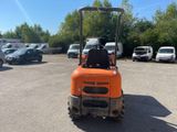 a small orange fork truck parked in a parking lot