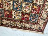 a rug hanging on the wall in a room
