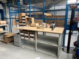 a workbench in a warehouse with many boxes on it