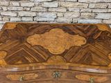 an image of a wooden box sitting on top of a stone wall