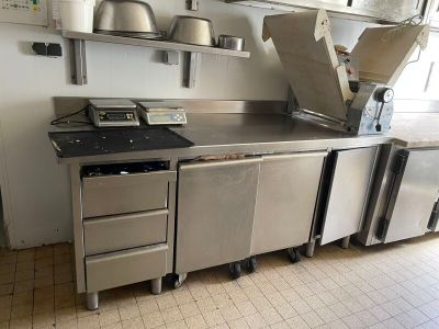 a kitchen that has a lot of stainless steel appliances in it