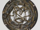 une image représentant une plaque métallique ornée d'un motif