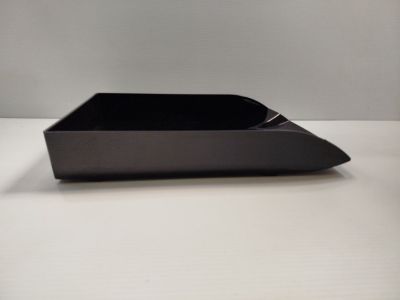 a black tray on a white table with a white background
