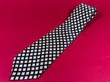 black and white checkered necktie on a pink background