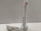 a toothbrush that is sitting on a table next to a charger