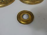 two brass candles on a white table with a white background