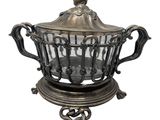 an image of a silver plate with a glass bowl on it