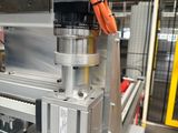 an image of a machine that is working on a piece of metal