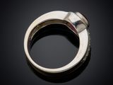 a close up of a silver ring on a black surface