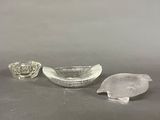three pieces of glass sitting on top of a table next to each other