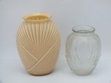 two vases sitting next to each other on a white surface