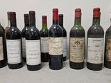 several bottles of wine are lined up on a counter