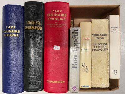 five books in a box on a white surface