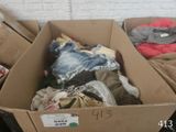 a cardboard box full of clothes and other items