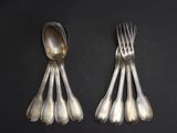 beaucoup de cuillères et de fourchettes en argent sur une table
