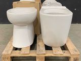 two toilets sitting on a pallet next to each other