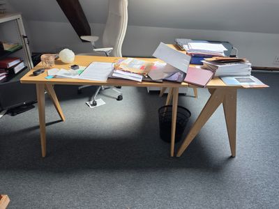 a desk with a lot of books and papers on it