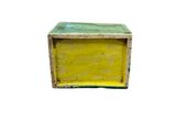 a yellow box with a green lid sitting on a white surface