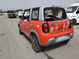 a small red car with flowers painted on the back