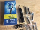 a box of toothbrushes sitting on a table next to a box of electric toothbrushes