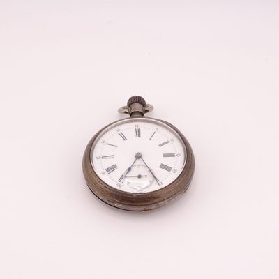 a silver pocket watch with roman numerals on the face