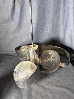 a glass pitcher with a spoon and a spoon rest on a table