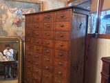 a dresser and a mirror in a room with a painting on the wall
