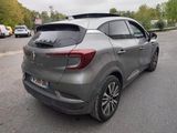 the rear end of a grey car parked on the side of the road