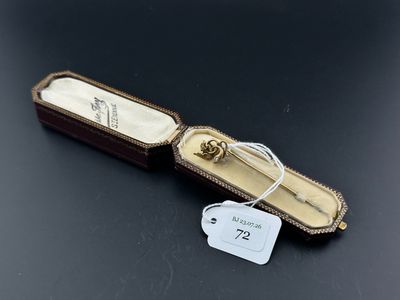 a close up of a gold ring in a case on a table