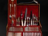 a red case with silverware in it on a black background
