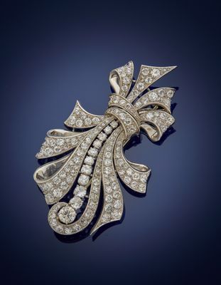 a diamond and gold broochle, by van cleef