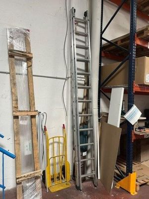 a room with a ladder, a ladder, and other items in it