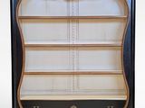 an image of a black and gold bookcase with shelves