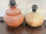 two vases sitting on a table next to each other