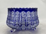 a close up of a blue glass bowl on a white surface