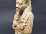 an egyptian statue of a woman holding a baby in her arms