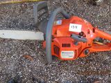 a chainsaw that is laying on the ground