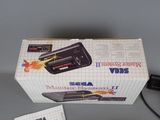a box with a video game on it and a charger