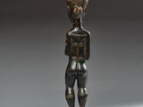 an image of a statue of a man standing on a wooden base