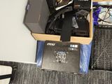 a person standing next to a box of electronics on the floor