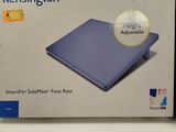 boxed box of a blue laptop computer sitting on top of a white table