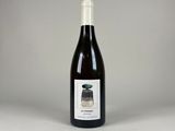 a bottle of wine sitting on top of a white table
