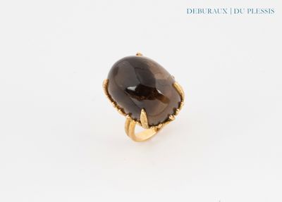 a close up of a ring with a brown stone on it