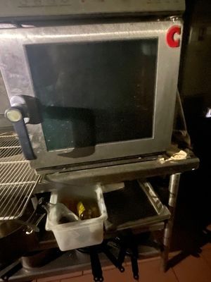 a microwave that is sitting on a shelf in a kitchen