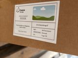 a cardboard box with a sticker on it sitting on a pallet