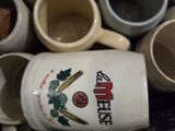 a pile of coffee mugs sitting on a shelf
